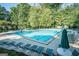 Large community swimming pool surrounded by chairs and trees at 2821 Amhurst Nw Way, Kennesaw, GA 30144