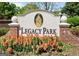 Legacy Park sign with colorful flowers surrounding base of the sign at 2821 Amhurst Nw Way, Kennesaw, GA 30144