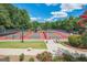 Exterior shot of the community tennis courts with trees in the background at 2821 Amhurst Nw Way, Kennesaw, GA 30144