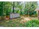 Spacious backyard with shed and play equipment, surrounded by lush greenery and mature trees at 2985 Westbury Dr, Decatur, GA 30033