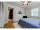 Well-lit bedroom boasts hardwood floors, a ceiling fan, and neutral wall color at 2985 Westbury Dr, Decatur, GA 30033