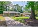 Well maintained single story home with a long driveway surrounded by beautiful mature trees at 2985 Westbury Dr, Decatur, GA 30033