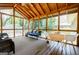 Relaxing screened-in porch with wood-paneled vaulted ceiling, stylish furnishings, and backyard view at 2985 Westbury Dr, Decatur, GA 30033