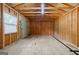 Inside the shed shows bare floors, walls, rafters and a single window providing ample light at 2985 Westbury Dr, Decatur, GA 30033