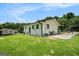 Spacious backyard featuring a well-maintained lawn, patio area, and mature trees, perfect for outdoor enjoyment at 4020 Ester Sw Dr, Atlanta, GA 30331