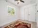 Clean bedroom with wood floors, closet, and a vibrant rug, offering a comfortable and stylish space at 4020 Ester Sw Dr, Atlanta, GA 30331