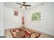 Clean bedroom with wood floors, a vibrant rug, and a modern light fixture at 4020 Ester Sw Dr, Atlanta, GA 30331