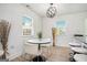 Bright dining area with modern light fixture, table with chairs, and a view of the yard at 4020 Ester Sw Dr, Atlanta, GA 30331
