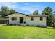 Charming home featuring a well-manicured lawn and freshly painted exterior, complete with black trim accents at 4020 Ester Sw Dr, Atlanta, GA 30331