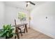 Bright home office features a wood desk, white chair, wood floors, and a contemporary lamp at 4020 Ester Sw Dr, Atlanta, GA 30331