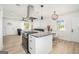 Open-concept kitchen with granite island, stainless steel hood vent, and seamless flow to the living room at 4020 Ester Sw Dr, Atlanta, GA 30331