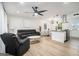 Contemporary living space with stylish furniture, sleek ceiling fan, and an open layout connected to the kitchen at 4020 Ester Sw Dr, Atlanta, GA 30331