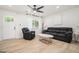 Bright living room featuring wood-look floors, neutral paint, and contemporary furnishings at 4020 Ester Sw Dr, Atlanta, GA 30331