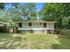The home's backyard features a wooden fence and an open area with short grass at 114 Howell Dr, Atlanta, GA 30331