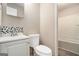 A bathroom featuring a toilet, white vanity, sink, and shower at 114 Howell Dr, Atlanta, GA 30331