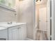 Functional bathroom with modern vanity, white cabinets, and convenient access to the adjacent toilet area at 114 Howell Dr, Atlanta, GA 30331