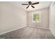 A bright bedroom featuring neutral walls, carpet, a ceiling fan, a window, and a closet at 114 Howell Dr, Atlanta, GA 30331