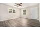 Inviting bedroom featuring wood-look flooring, a ceiling fan, and ample natural light at 114 Howell Dr, Atlanta, GA 30331