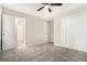 A bedroom with gray carpeting, off-white walls, and a double closet with sliding doors at 114 Howell Dr, Atlanta, GA 30331