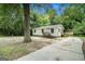 Front exterior of a home with a concrete driveway, small porch, and siding at 114 Howell Dr, Atlanta, GA 30331