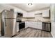Well-equipped kitchen boasts stainless steel appliances, sleek white cabinetry, and modern countertops at 114 Howell Dr, Atlanta, GA 30331