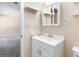 Bright bathroom featuring a white vanity, shelving, and medicine cabinet at 9719 Dixon Industrial, Jonesboro, GA 30236