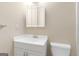 Bright bathroom with a white vanity, a medicine cabinet, and a commode in a well-lit space at 9719 Dixon Industrial, Jonesboro, GA 30236