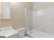 Cozy bathroom featuring a white tub with tiled surround and a matching commode and sink at 9719 Dixon Industrial, Jonesboro, GA 30236