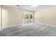 Bright bedroom with neutral walls, bay windows, plush carpeting, and modern design elements at 9719 Dixon Industrial, Jonesboro, GA 30236