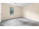 Comfortable bedroom with neutral walls, plush carpeting, and a bright window, perfect for relaxation at 9719 Dixon Industrial, Jonesboro, GA 30236