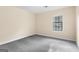 Cozy bedroom with neutral walls, plush carpeting, and a window offering natural light and a serene ambiance at 9719 Dixon Industrial, Jonesboro, GA 30236