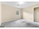 Comfortable bedroom featuring neutral walls, plush carpeting, a closet, and a window for natural light at 9719 Dixon Industrial, Jonesboro, GA 30236
