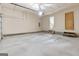 Spacious garage with concrete flooring, white walls, an overhead door, and interior access at 9719 Dixon Industrial, Jonesboro, GA 30236