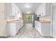 Traditional style kitchen featuring white cabinets, white appliances, and light countertops at 9719 Dixon Industrial, Jonesboro, GA 30236