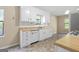 A view of the kitchen with a stainless steel refrigerator, white appliances, cabinets, and countertops at 9719 Dixon Industrial, Jonesboro, GA 30236