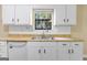 Close-up of kitchen sink with stainless steel faucet and white cabinets and countertops at 9719 Dixon Industrial, Jonesboro, GA 30236