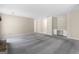 Spacious living room with gray carpet, built-in shelves, and modern lighting at 9719 Dixon Industrial, Jonesboro, GA 30236