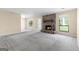 Bright living room featuring a stone fireplace, plush carpeting, and natural light at 9719 Dixon Industrial, Jonesboro, GA 30236