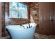Bright bathroom with a soaking tub and natural light at 297 Collegiate Dr, Powder Springs, GA 30127