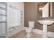 Bathroom featuring a pedestal sink, toilet, and shelving with cabinets at 297 Collegiate Dr, Powder Springs, GA 30127