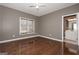 This bedroom boasts hardwood floors, neutral paint, a ceiling fan, and an ensuite bathroom for added convenience at 297 Collegiate Dr, Powder Springs, GA 30127