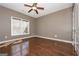 Spacious bedroom features wood floors, a large window, and a ceiling fan at 297 Collegiate Dr, Powder Springs, GA 30127