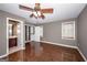 Bedroom features wood floors, ceiling fan, windows and a doorway to the bathroom and closet at 297 Collegiate Dr, Powder Springs, GA 30127