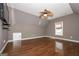 Spacious bonus room with vaulted ceilings, hardwood floors, natural light, and ready for a tv at 297 Collegiate Dr, Powder Springs, GA 30127