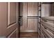 Walk-in closet with custom wood shelving and drawers at 297 Collegiate Dr, Powder Springs, GA 30127