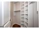 Walk-in closet with custom shelving and rod at 297 Collegiate Dr, Powder Springs, GA 30127