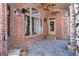 Inviting covered patio with brick accents, stone detailing, and ample space for outdoor relaxation and gatherings at 297 Collegiate Dr, Powder Springs, GA 30127