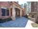 Charming covered porch with stone columns, an outdoor fireplace, and a built-in grill, perfect for entertaining at 297 Collegiate Dr, Powder Springs, GA 30127