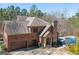 Stunning brick home with a three-car garage, stone accents, a private pool, and lush landscaping at 297 Collegiate Dr, Powder Springs, GA 30127
