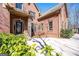 Stately brick home showcasing an arched entryway and meticulously landscaped front yard at 297 Collegiate Dr, Powder Springs, GA 30127